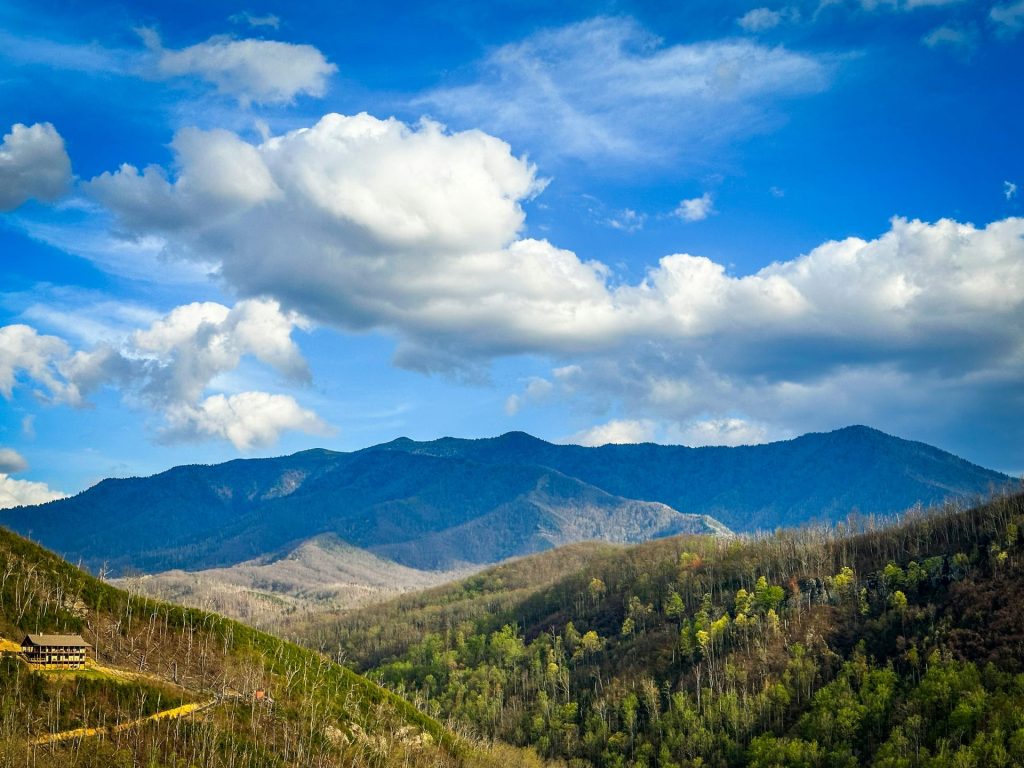 a scenic view of a mountain range with clouds in the sky